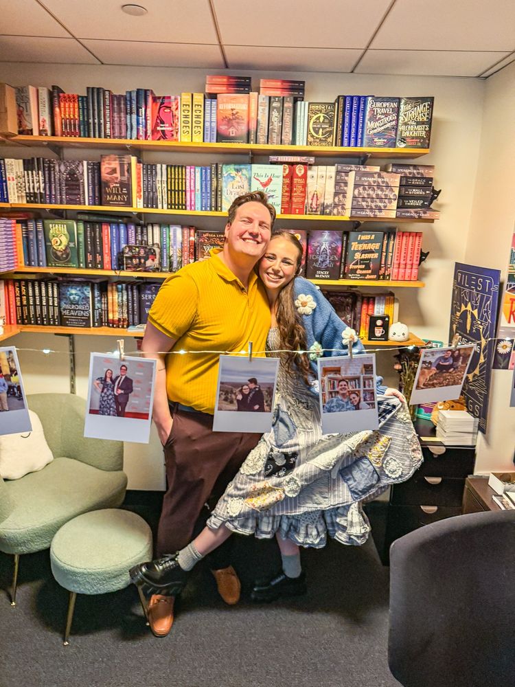 Kyle and Steph in front of a bookshelf