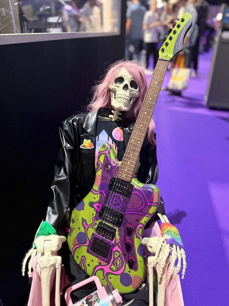 a skeleton holding the Streamcaster at TwitchCon