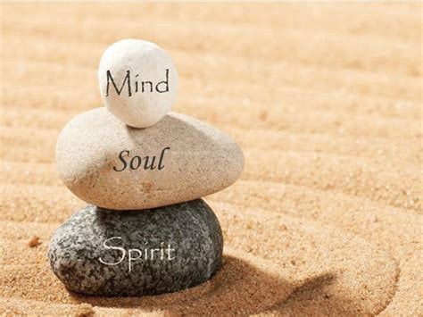 Three stacked rocks in the sand.  From top to bottom the words, "Mind", "Soul", and "Spirit"