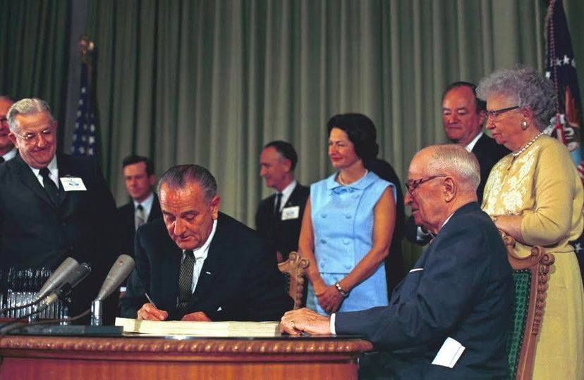 President Lyndon Johnson signing Medicaid and Medicare into law on this day in 1965