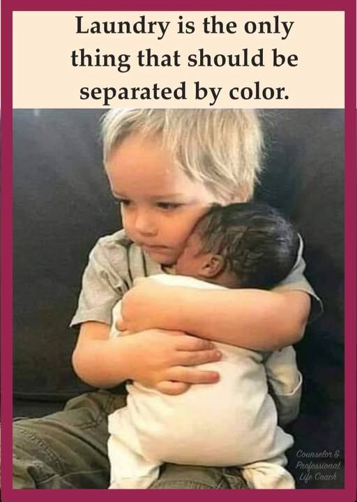 A white toddler holding a black baby.  The caption reads, "Laundry is the only thing that should be separated by color.