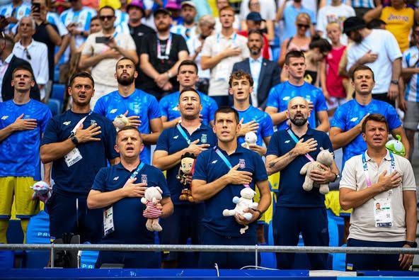 The Ukrainian delegation to the 2024 Olympics holding children's toys at the opening ceremony