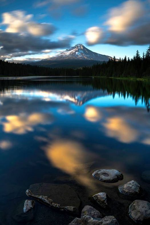 A mountain and sky reflecting on a lake.
Photographer unknown