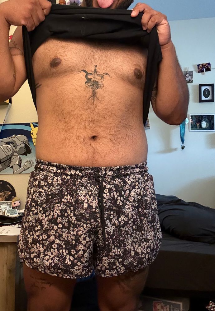 Arrow lifting up his shirt to flash the camera a bit 