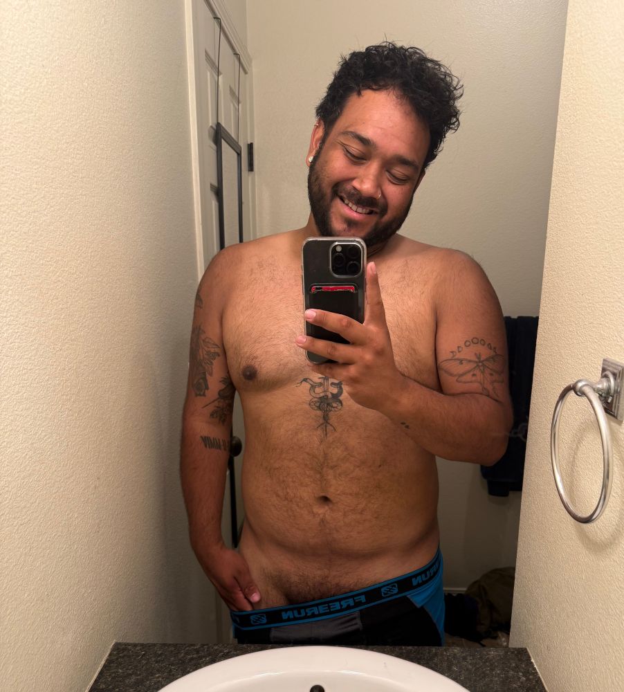 Arrow taking a selfie in his bathroom while pulling down his compression shorts to tease at what is underneath. 