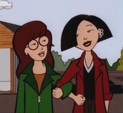 A frame still from MTV’s animated show: Daria. Daria is standing next to Jane and they have linked their arms together.