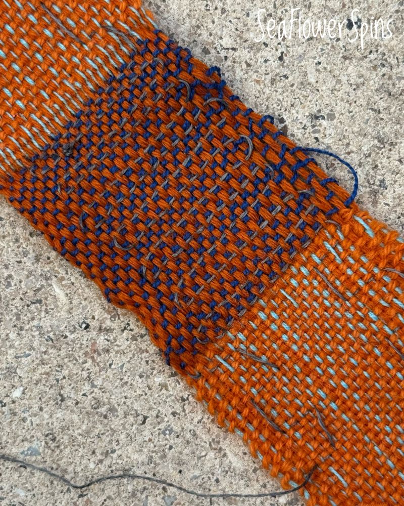 A small woven pice (5cm wide) with an integrated circuit made from conductive thread. The thread connects three LEDs 
to a 3V button battery (not pictured). This close-up shows a small pocket double-woven, with the conductive thread snaking through the warp - this is where a pressure-sensitive switch will be inserted. 