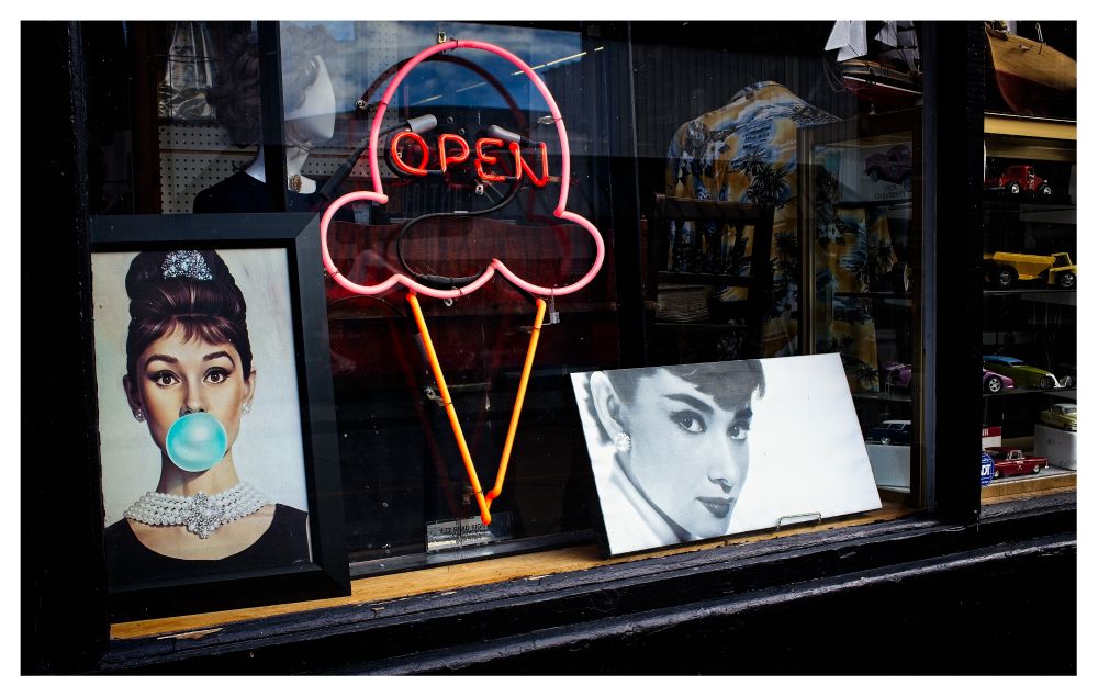 Shop window with two posters of Audrey Hepburn.
