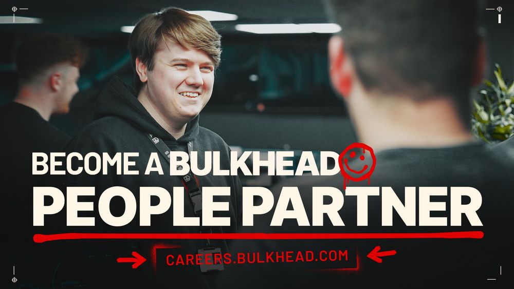 Photo of BULKHEAD Developers laughing in-office, with People Partner role advertised as text overlayed.