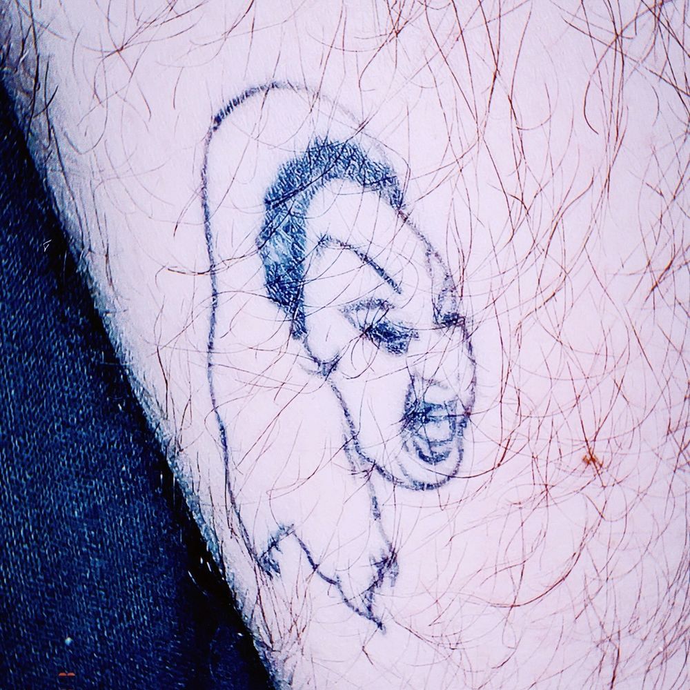 A thigh tattoo of divine