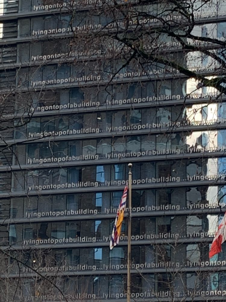 Building with the text “lyingontopofabuilding” repeated over and over on the front of it