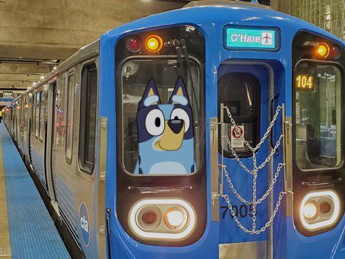 A Chicago Transit Authority 7000-series "L" train car, with Bluey from the show "Bluey" in the front window.