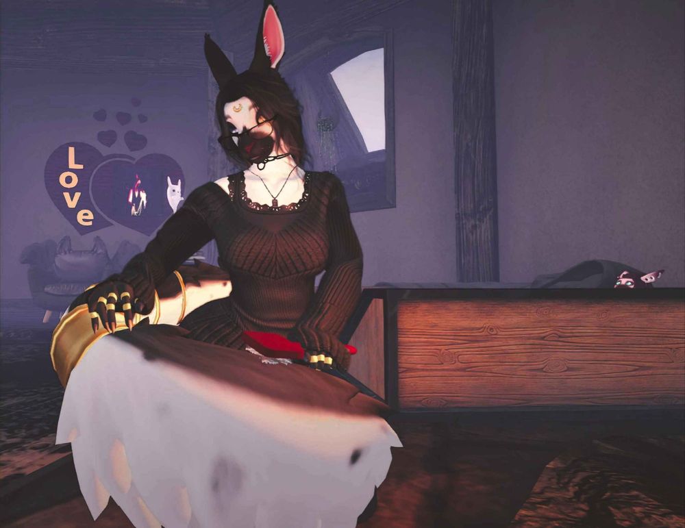 A furry female character with black markings, bunny ears, and a dark outfit is sitting in a dimly lit room. She appears to be holding her tail while she uses a brush on it. There's a wooden bed in the background with a plush that resembles her boyfriend, and a "Love" sign on the wall with a picture of her boyfriend in the heart.