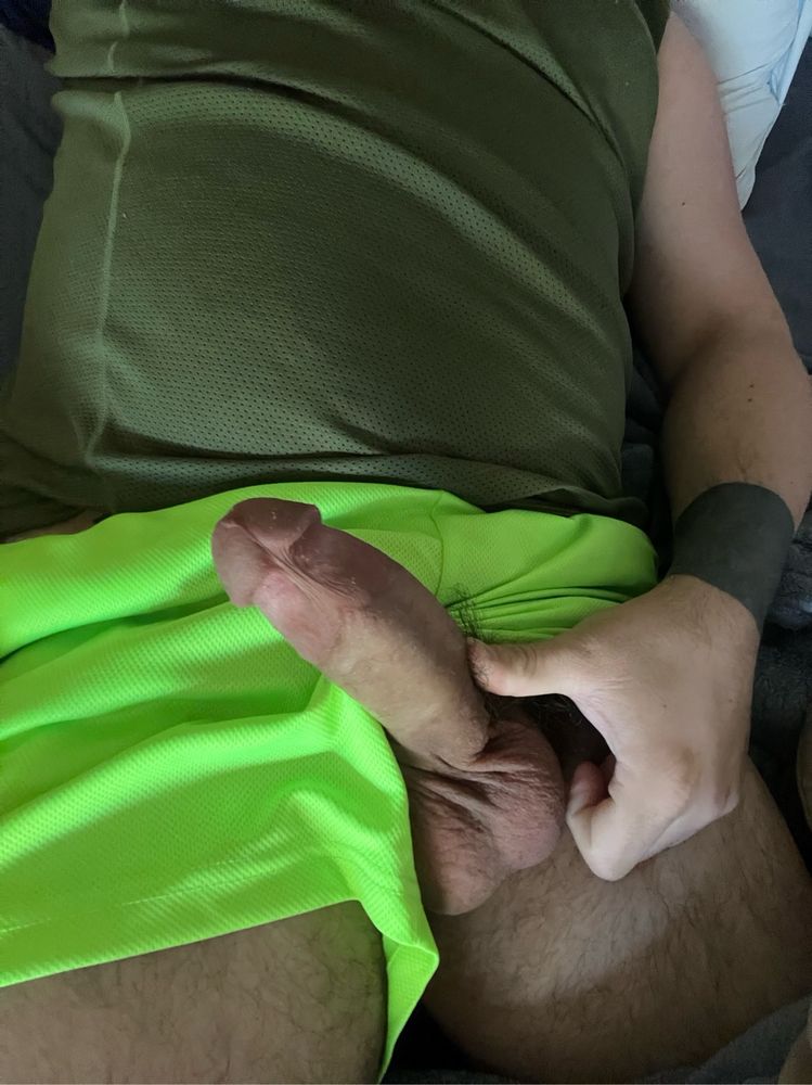 My hard cock. I’m wearing a dark green tank top and highlighter green short shorts