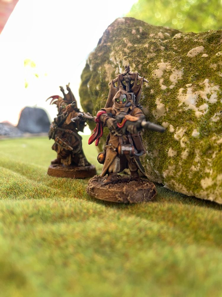 A ganger and gang leader using cover to stay hidden from the enemy.