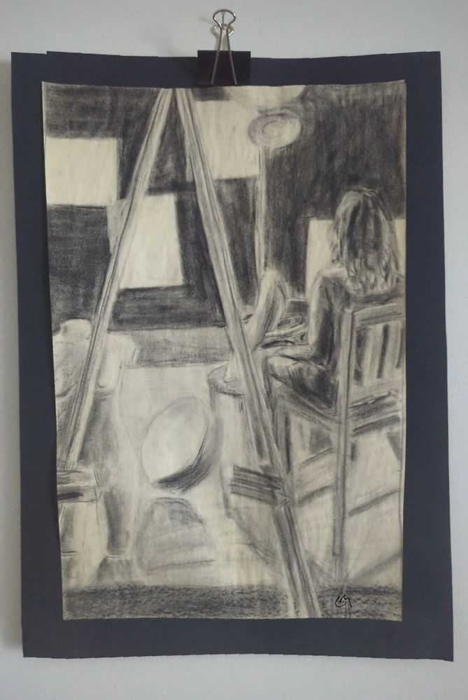 A Conte life drawing from 2014 an easel sits in front of a partial mannequin and a seated human model