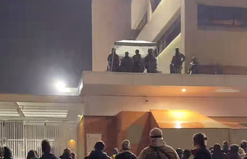 ICE goons cowering in a tent in the rain on roof of ICE building in PDX 