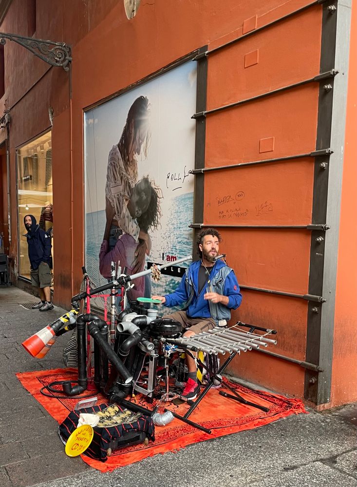 street performer with recycled items comprising a one-man band.