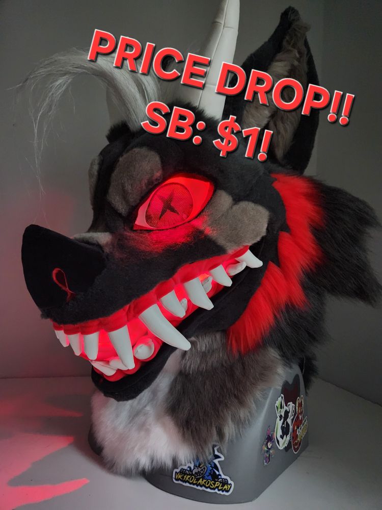 A hellhound fursuit head with horns, long hair, and glowing eyes and mouth, listed for $1.