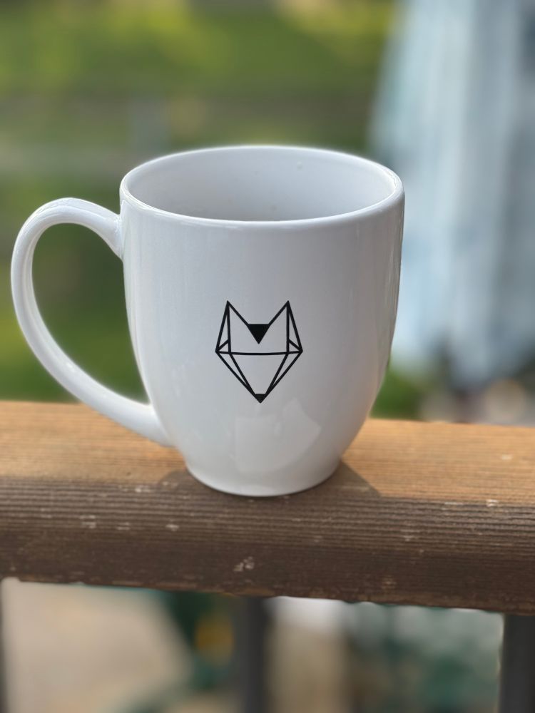  Full coffee cup sitting on porch railing on sunny morning