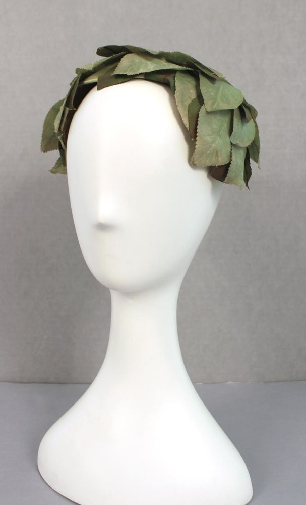 Cap of green silk taffeta leaves and beige net: open crown, slight points at L and R side; lined.