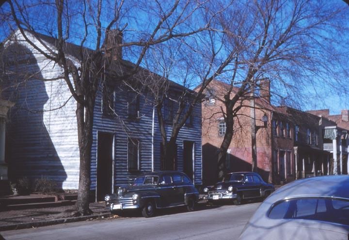 35mm color slide of 822 - 824 N. 2nd Street at Baker Street, in the Jackson Ward neighborhood; image shows a two-story frame double house with tin roof and center chimney; Richmond, Virginia.