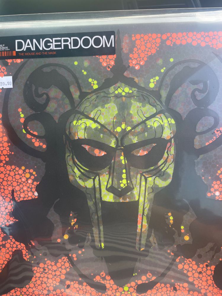 Vinyl copy of “The Mouse & the Mask” by DANGERDOOM, the collaboration between MF Doom, Danger Mouse, and the bulk of the early 2000s Adult Swim roster. What could’ve been a throwaway novelty or goof is a shining jewel in MF Doom’s crown.