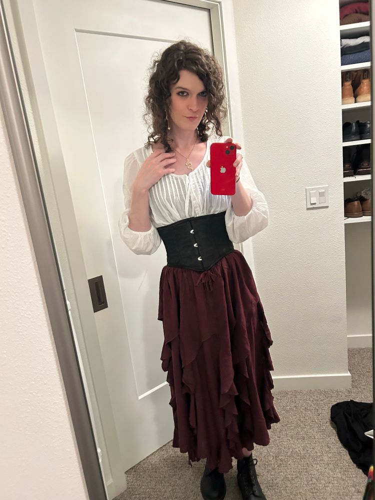 me posing in a red skirt, white blouse, and black corset