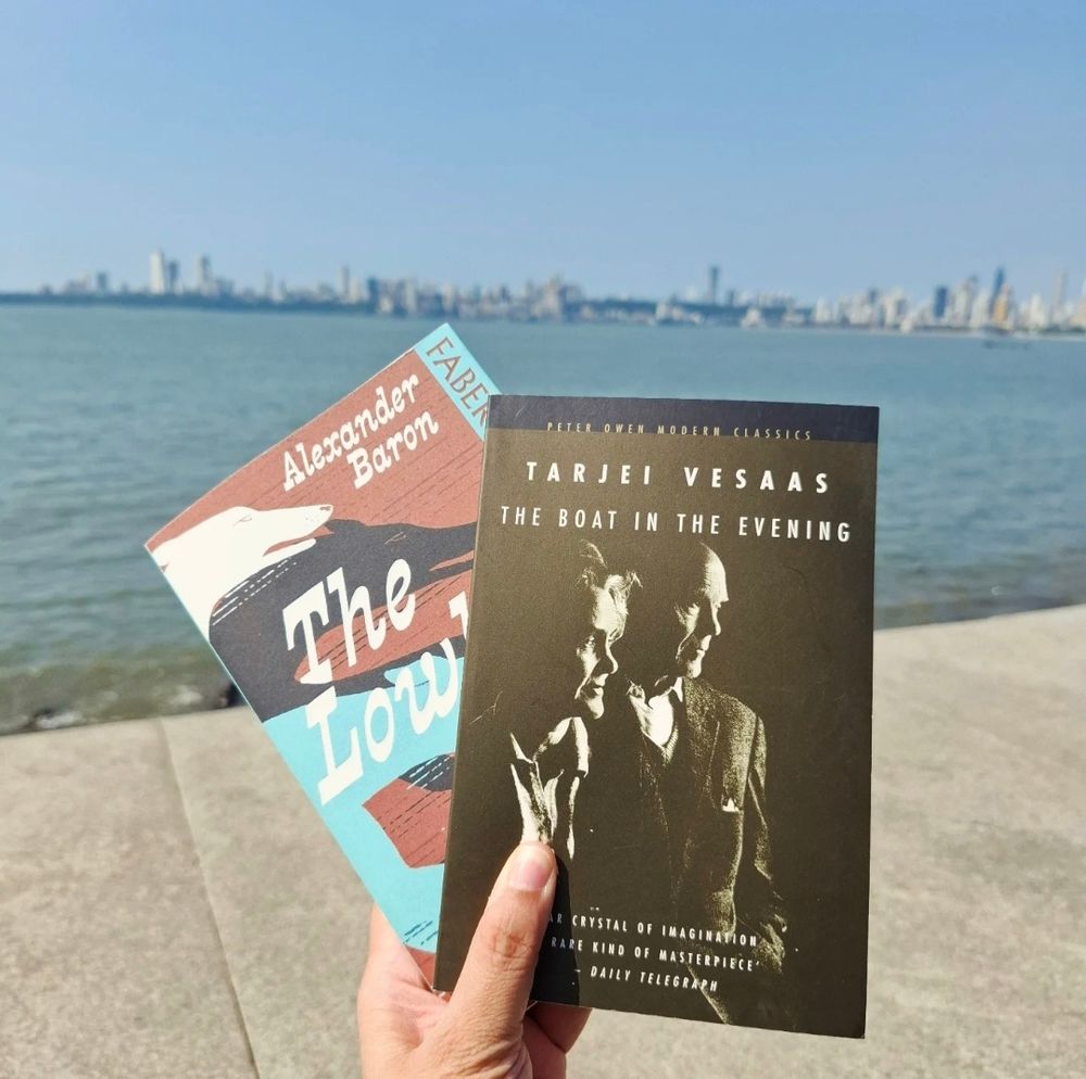 Two books with the Arabian Sea in the background. The books are  The Lowlife by Alexander Baron and The Boat in the Evening by Tarjei Vesaas.