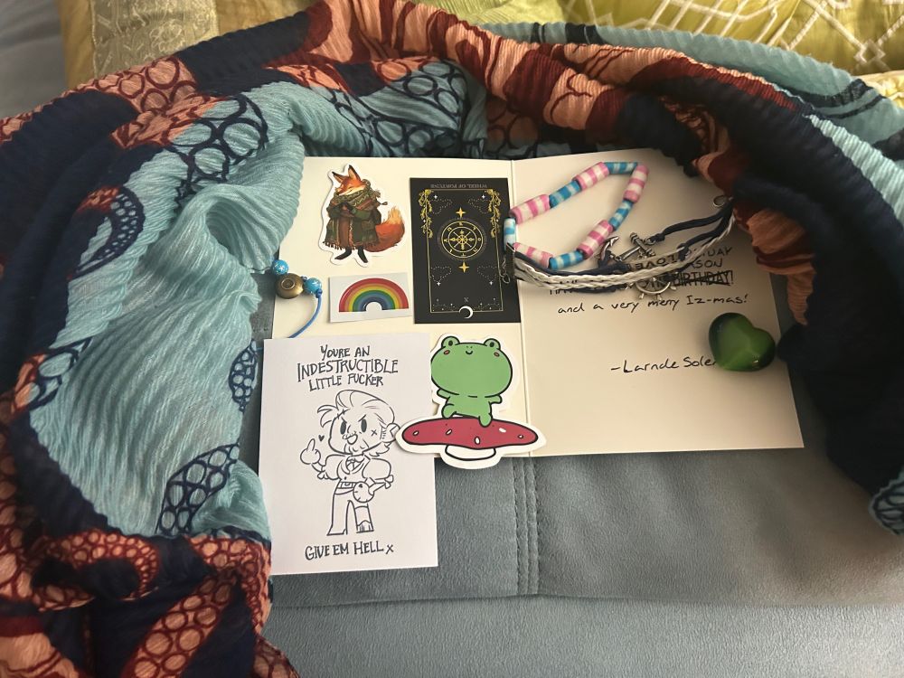 Gift collection from best Canyonite including colorful scarf, braclets, stickers, a green stone, and Izzy swag!