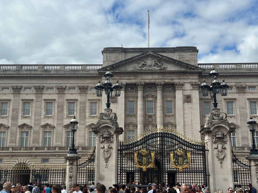 The front of Buckingham Palace.  There are hundreds of tourists in front of the closed gate but, contrary to the conspiracy theory, the windows are not boarded up.