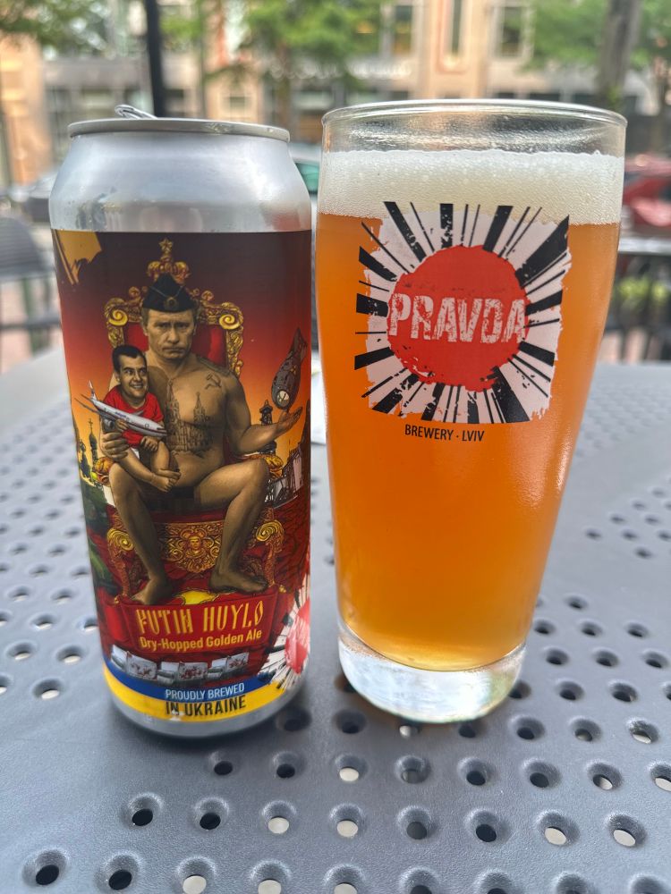 A can of beer next to a full pint glass, sitting on an outdoor cafe table.

The beer is ‘Putin Huylo’ from Pravda Brewery in Lviv.  ‘Putin Huylo’ roughly translates to ‘Putin is a Dickhead’
