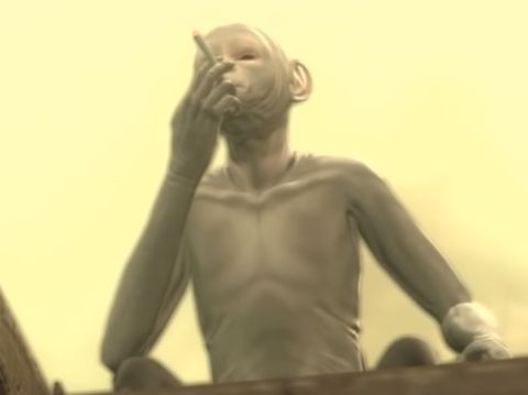 The bald monkey from Metal Gear Solid 4 smoking a cigarette
