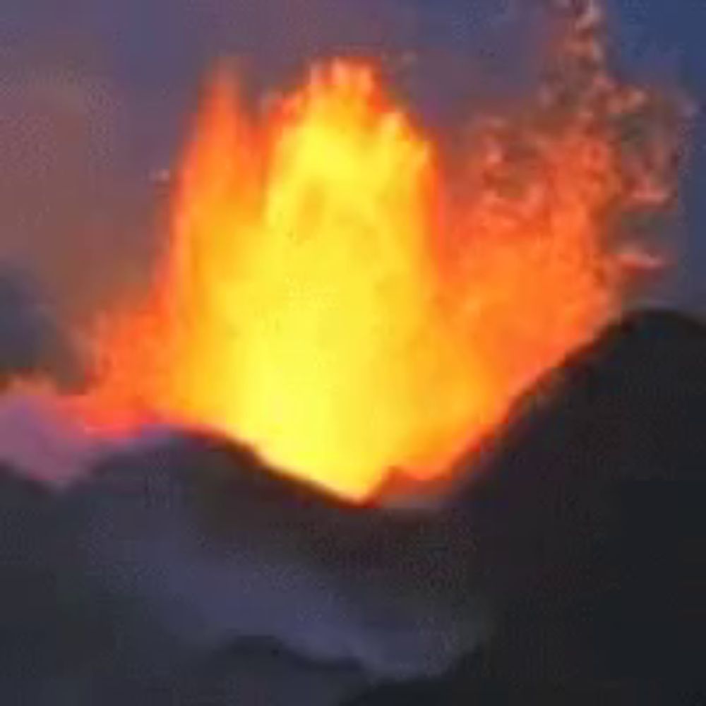 a large fireball is erupting from a volcano in the night sky