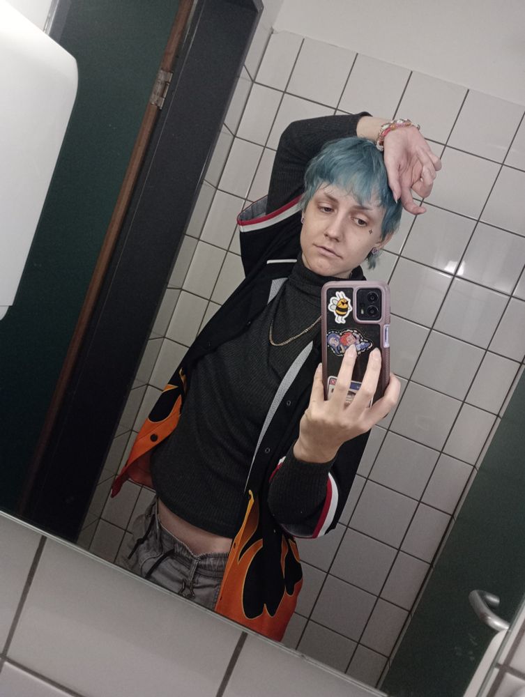 selfie of me, a white person with blue hair and a flame shirt