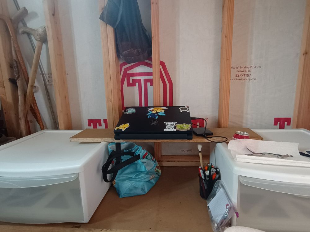 a makeshift table made from a board and a few plastic drawers