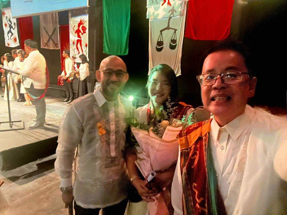 Photo of my husband, me, and Dr. Wendell Capili at the College of Arts and Letters graduation