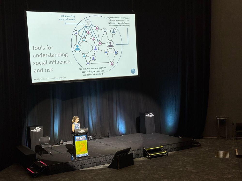 Speaker Jess Melbourne-Thomas at podium in Darwin Convention Centre talking about social networks 