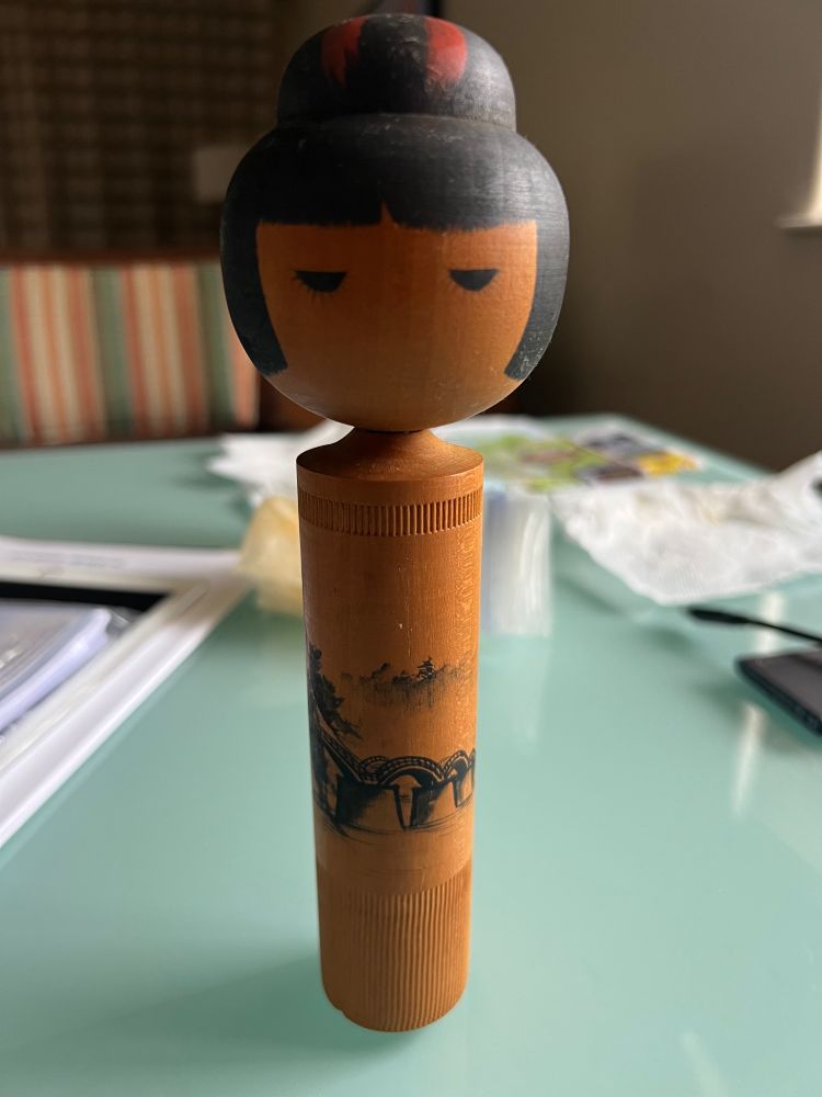 The front view of a kokeshi doll obtained in Kaleakekua, Big Island, Hawaii.