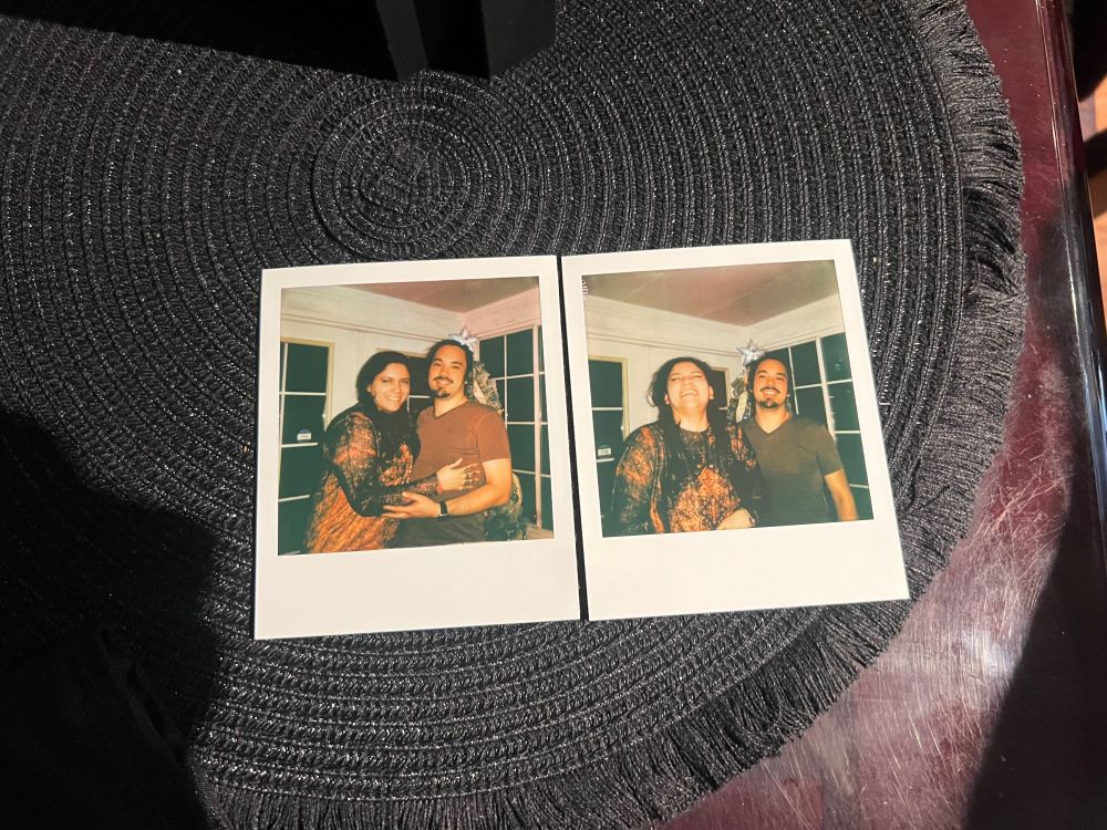 Two Polaroids of Nick and Britney posing in front of a Christmas tree.