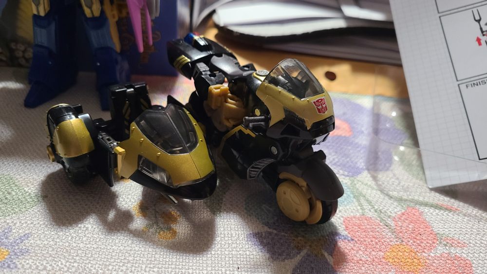 Legacy Animated Universe Prowl with the DNA DK-42 upgrade kit in its side car mode.