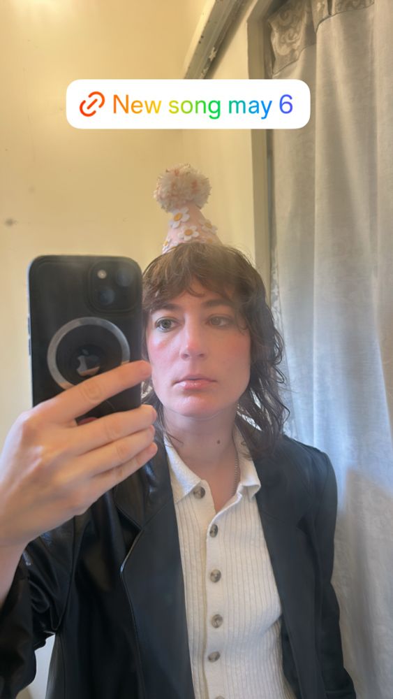 A mirror selfie where i am wearing a clown hat