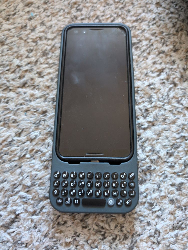 A Pixel 3 in a Pixel 3 case in a Pixel 9 Clicks keyboard case.