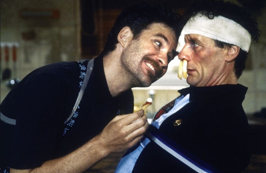 Screenshot from A fish Called Wanda where Kevin Kline is torturing Michael Palin