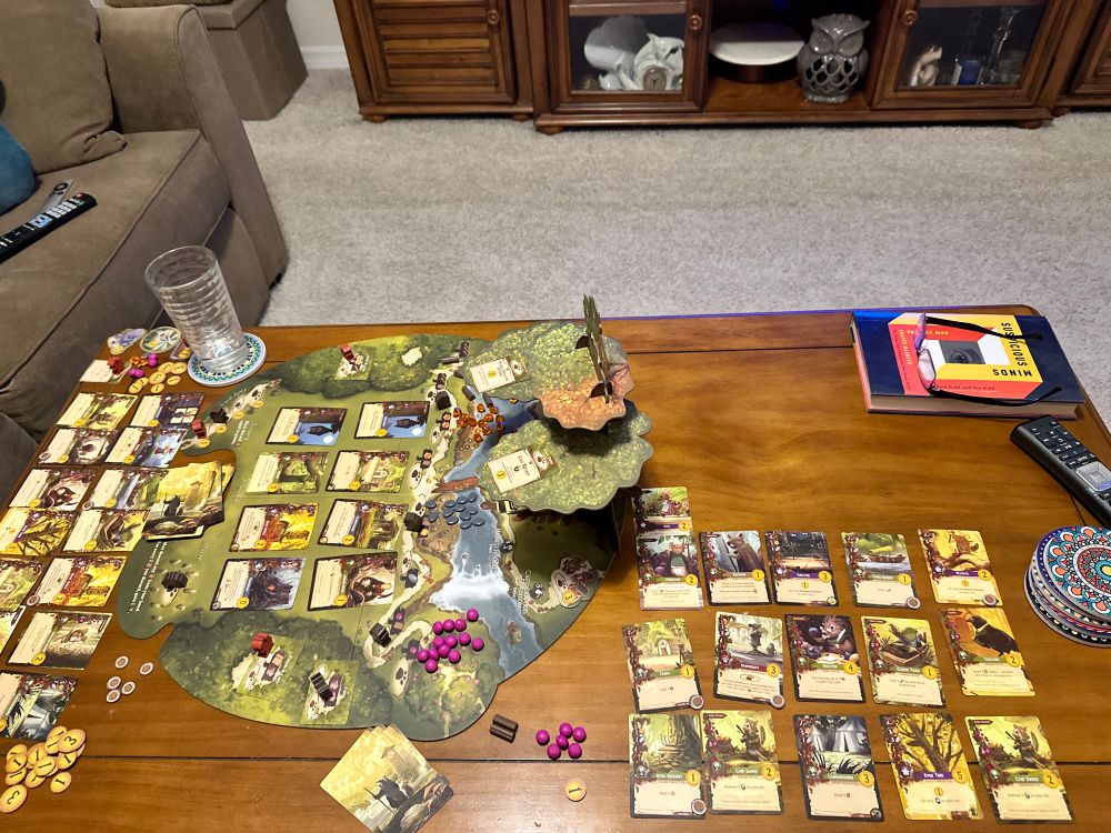 setup of the game ‘Everdell’ on a coffee table.