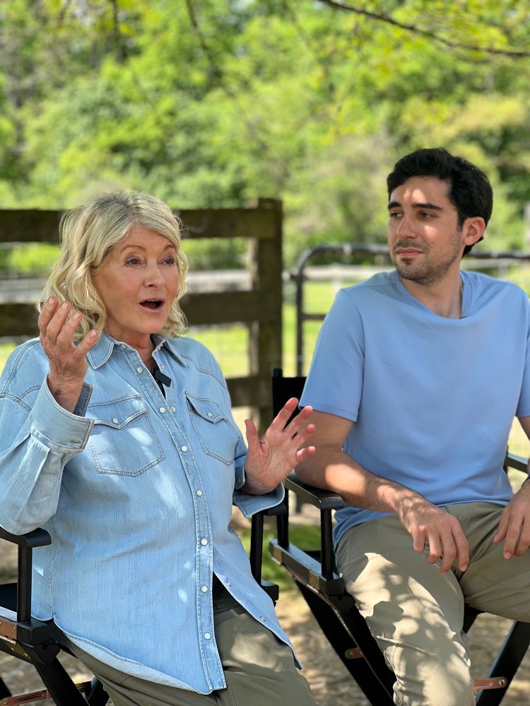 Martha and Ari wearing accidentally matching blue hued shirts 
