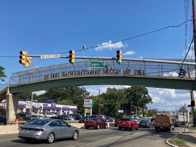 Sign on pedestrian bridge reads No ice concentration camps in NJ