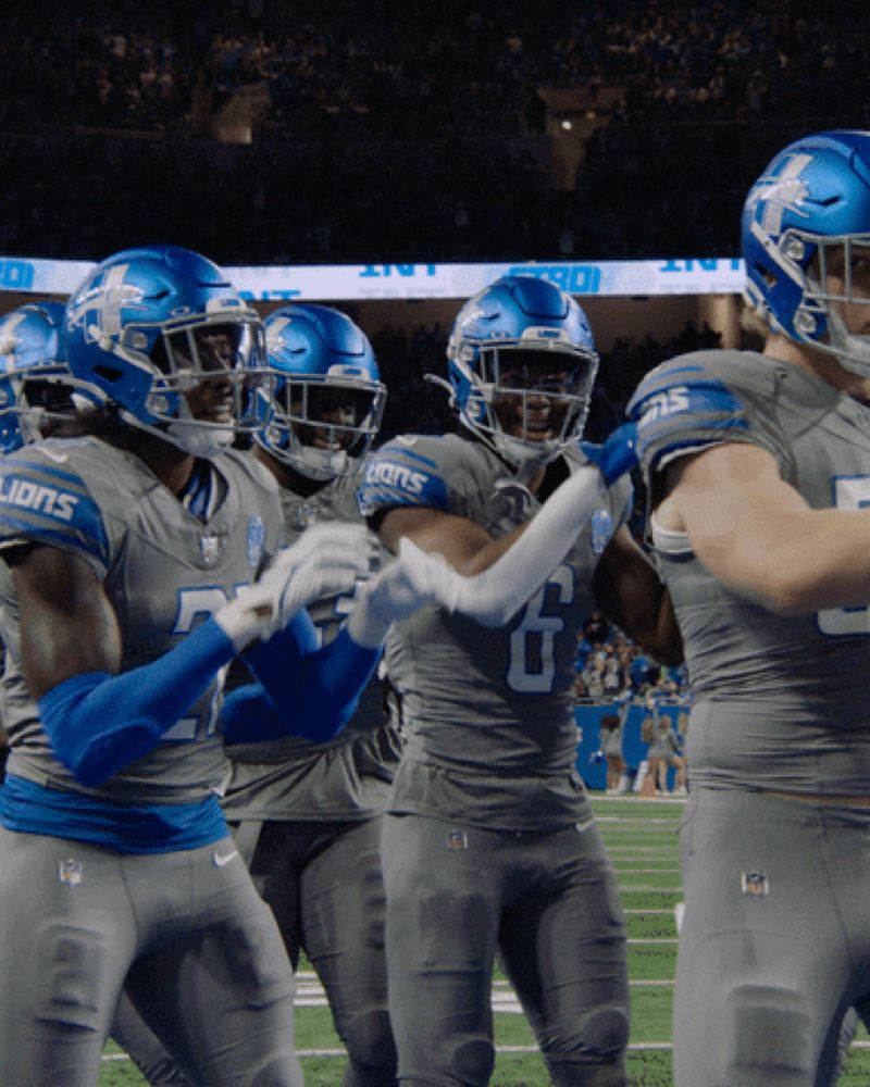 a group of football players wearing lions uniforms