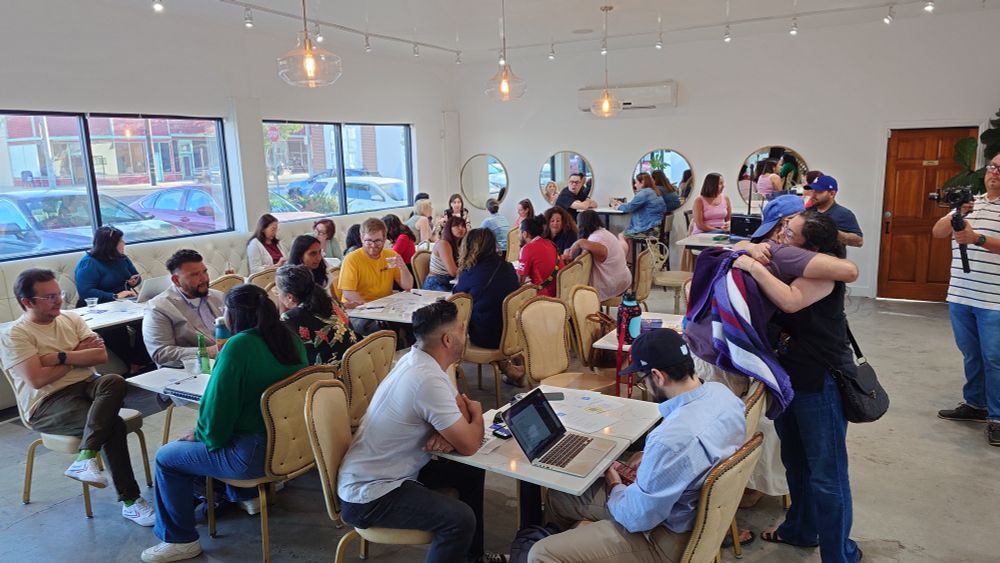 People socialize before the club meeting begins. 