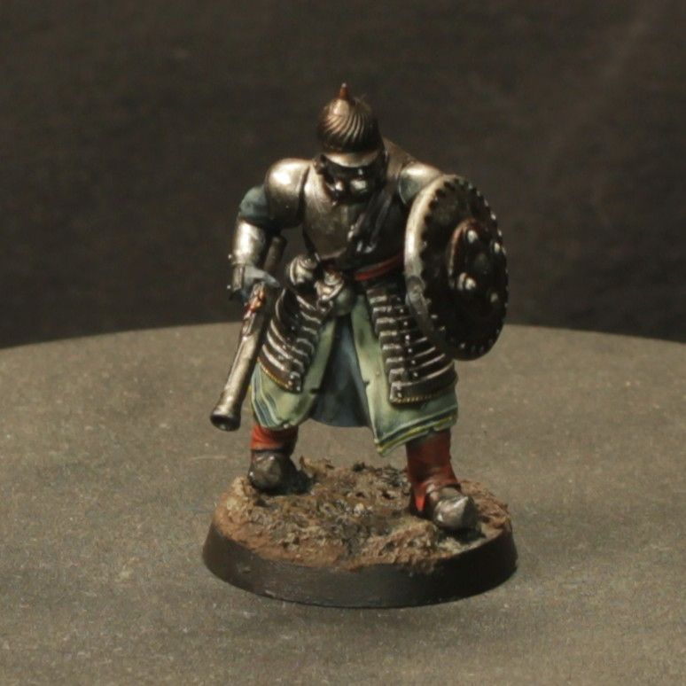 Front view of the Sapper miniature for Trench Crusade. It has a pistol in one hand and a shield in the other. 